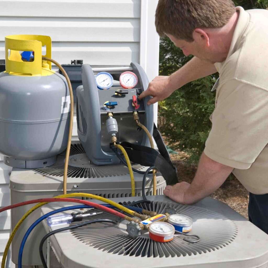 A man repairing air conditioning device