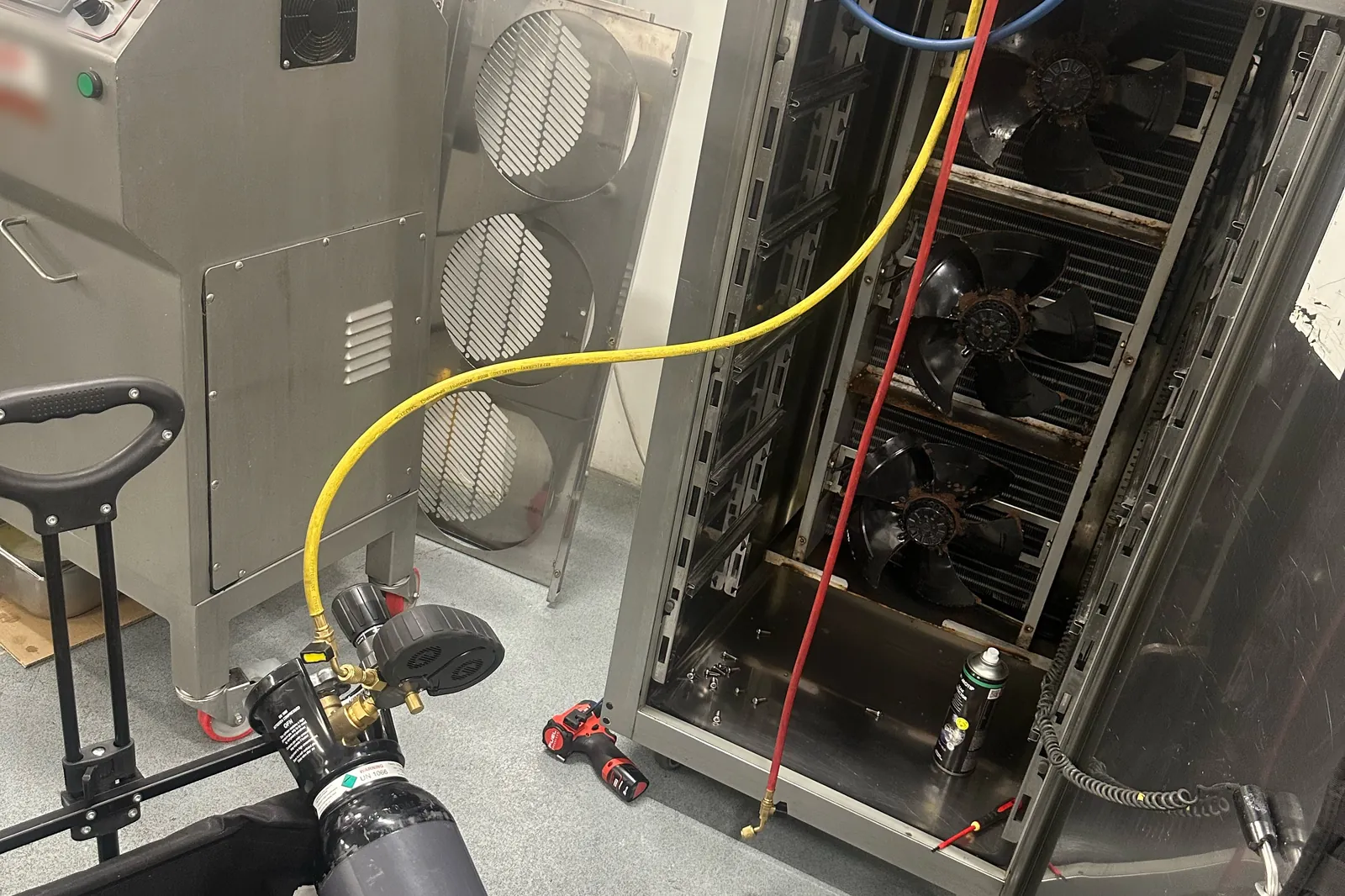 Blast chiller opened up for a nitrogen pressure leak test, with the nitrogen cylinder and hose connected